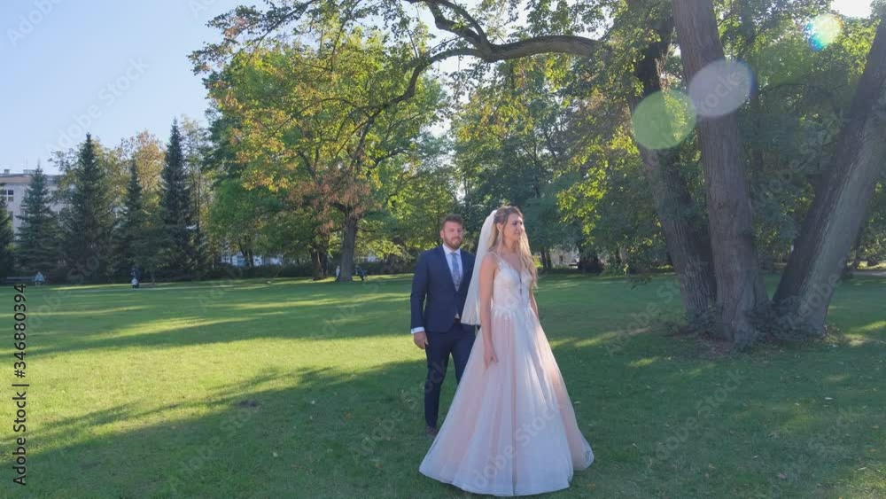 Full shot of Bride and groom are performing their first dance in the park. Full shot of Bride and groom are performing their first dance in the park.