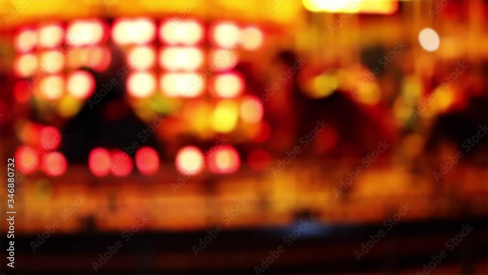 Defocused carousel ride shot showing lights and movement of the carnival fun nights Defocused carousel ride shot showing lights and movement of the carnival fun nights
