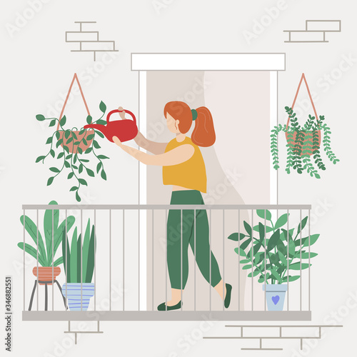 Cute female person watering houseplants on the balcony. Plants growing hobby concept.