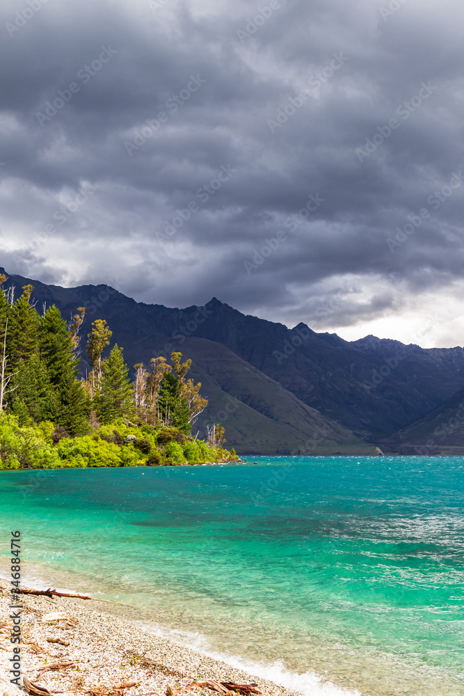 Mountain peaks above the turquoise. Lake Wakatipu, New Zealand