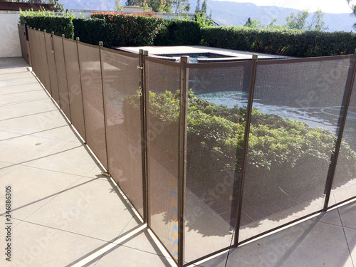 Safety fence at swimmimg pool with child protection gate for drowning
