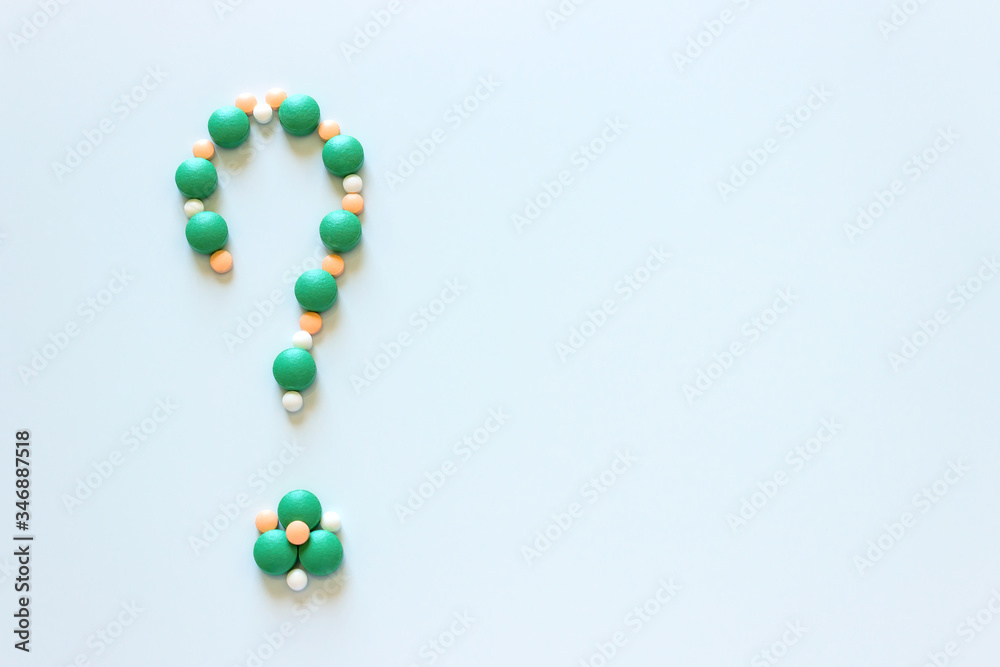 Question mark is made up of colored tablets. The concept of choice of treatment. Question mark is made up of colored tablets. The concept of choice of treatment.