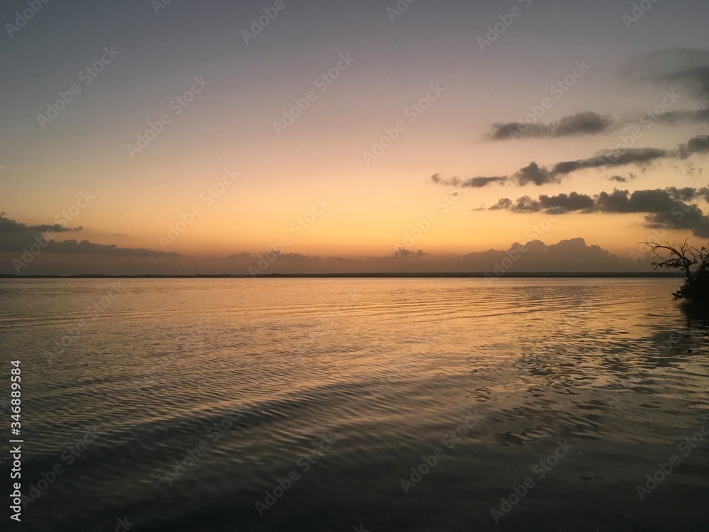 Beautiful ocean view with clean water, evening, night. Amazing background of island, Caribbean, Lagoon Bacalar. Calm secluded place without people, paradise. Sunset or sunrise