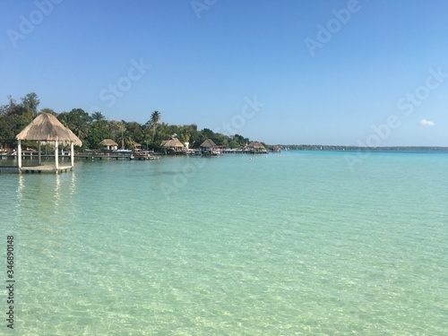 Beautiful ocean view with clean blue turquoise water  sunny day. Amazing background of island  Caribbean  Lagoon Bacalar. Calm secluded place without people  paradise