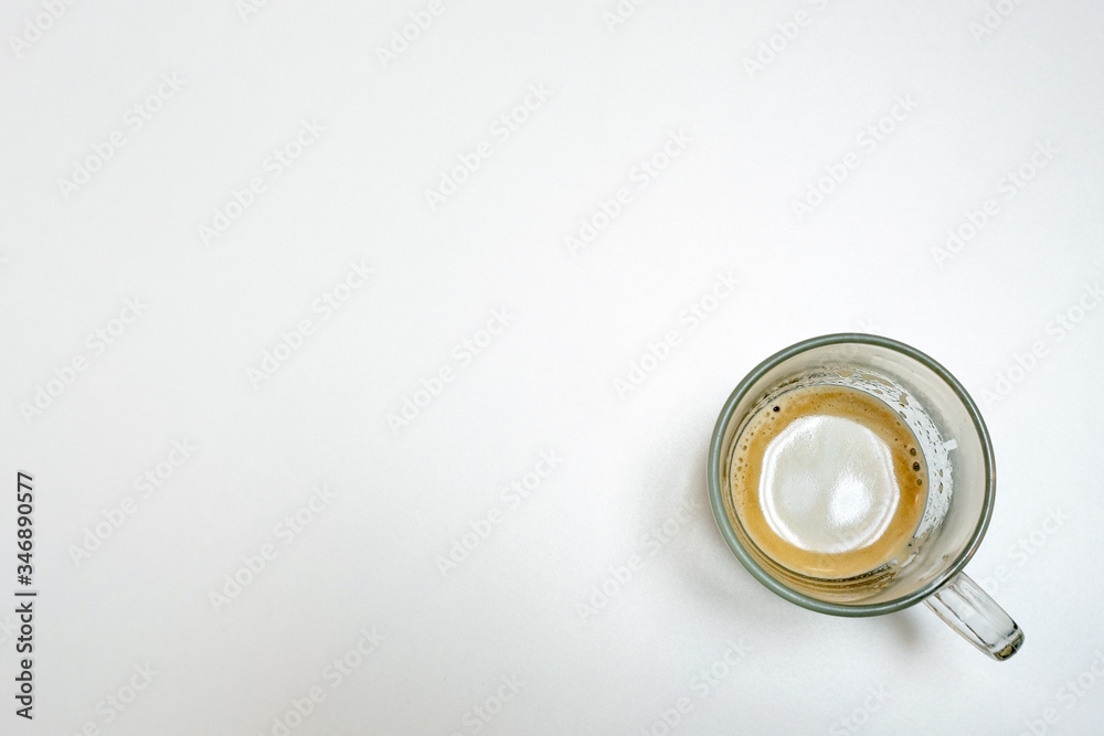 A cup of coffee with milk on the white table, Top view
