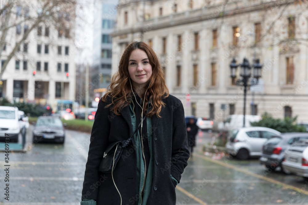 Fototapeta premium Young Urbanite Woman with Genuine Smile Posing in City