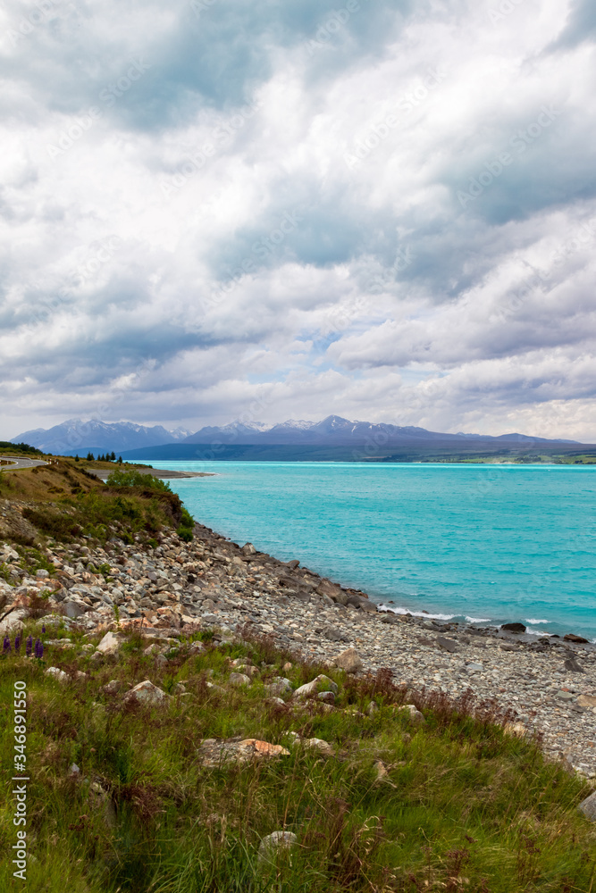 Mountains over turquoise water. Trek towards the Southern Alps and Mount Cook, New Zealand