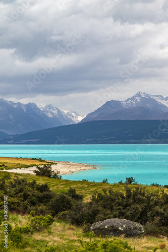 Pukaki lake. Mountains over a turquoise lake on the South Island. New Zealand