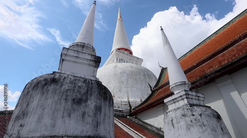 Wallpaper Mural elegant pagodas of  Wat Phra Mahathat Woramahawihan. The main Buddhist temple of Nakhon Si Thammarat Province in southern Thailand. The main stupa of the temple, Phra Borommathat Chedi. Blue sky day. Torontodigital.ca