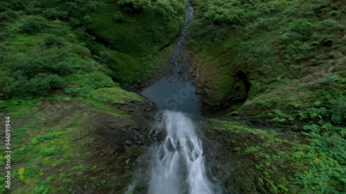 Aerial FPV Race Drone Jumping Over Waterfall to get Insane Unique Perspective of Falling Water into Secret Watering Hole in Hawaii photo