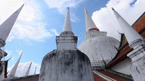 Wallpaper Mural elegant pagodas of  Wat Phra Mahathat Woramahawihan. The main Buddhist temple of Nakhon Si Thammarat Province in southern Thailand. The main stupa of the temple, Phra Borommathat Chedi. Blue sky day. Torontodigital.ca