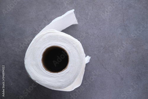 roll of toilet paper on gray background 