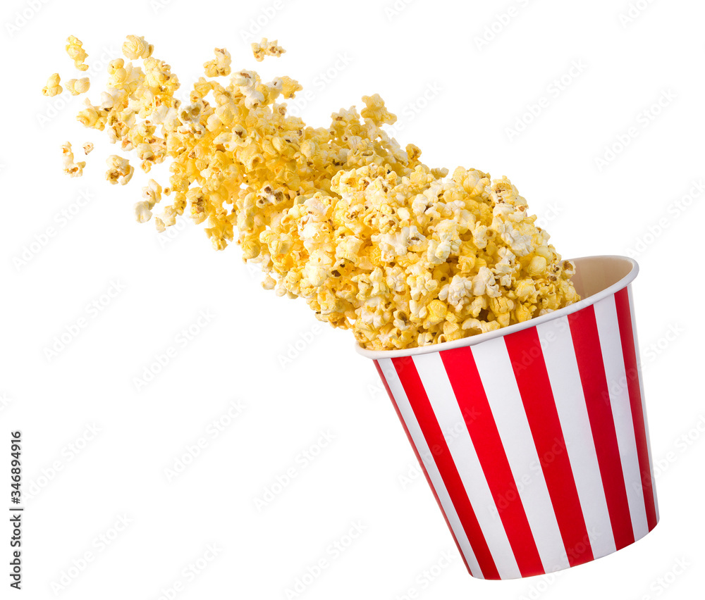Flying popcorn from paper striped bucket isolated on black background Flying popcorn from paper striped bucket isolated on black background