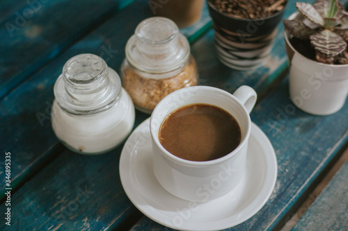 Durian coffee on a white mug. Blue wooden table. Rustic.