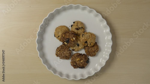 Cookies appear and disappear on a plate. Stop motion