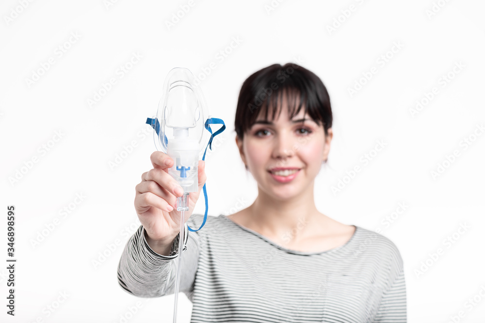 smiling female holding Nebulaizer inhale mask in her hand closeup. illness recovery concept smiling female holding Nebulaizer inhale mask in her hand closeup. illness recovery concept