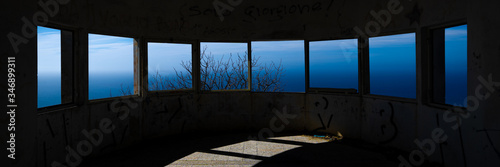 abandoned placwindows of an abandoned observatory on the seae windows overlooking the sea or ocean photo