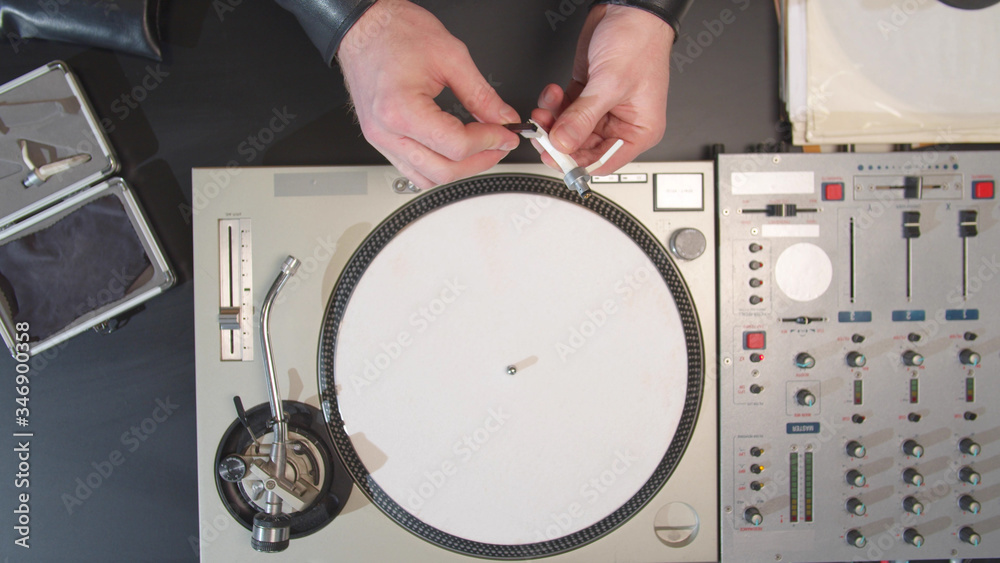 Sound engineer clean the turntable needle. Top view