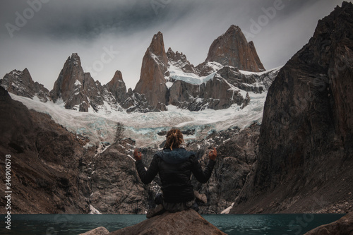 yoga man in the fitz roy mountain lake patagonia