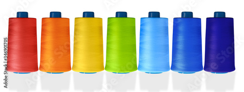 multicolored thread reels on a white background