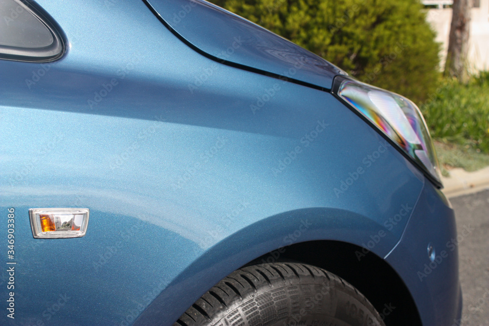 Close up of metallic blue vehicle fender