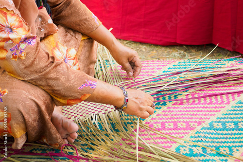 Obraz na płótnie Villagers are weaving mats made from a papyrus in various designs
