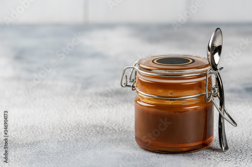Homemade salted caramel sauce. Selective focus, space for text.