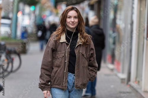 Young Woman Walking and Smiling at Camera