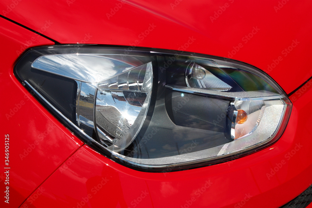 Headlight of a red car