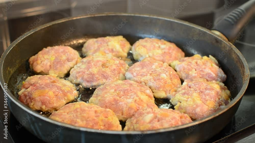 Cutlets are fried in a pan on an induction stove Cutlets are fried in a pan on an induction stove
