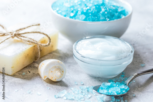 blue sea salt  soap and body cream on stone desk background