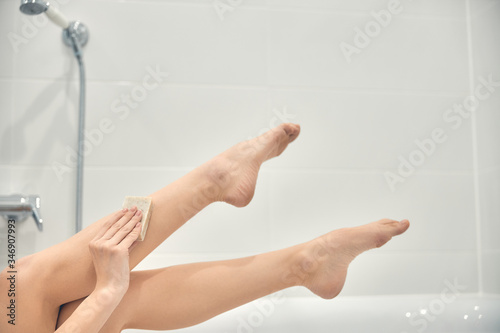 Caucasian lady lying in bath at home