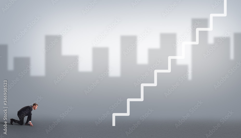 Business concept and career progress. The business person is preparing to start and looks at the career ladder on a gray background with the silhouette of the city.