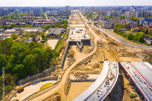 construction of new road at suburb area. aerial top view on industrial equipment and machinery working at city construction site