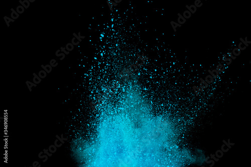 Explosion of blue, aqua and violet dust on black background.