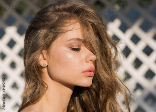 Fotografie Portrait of young pretty teen girl with blond long hair in summer