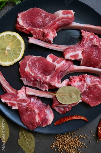 Raw fresh lamb ribs with spices on a dark background 