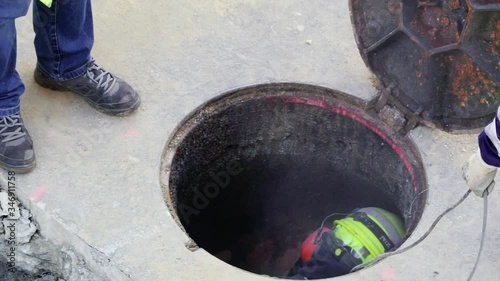 utility worker cleaning and repairing pipes inside the sewer , video hd footage