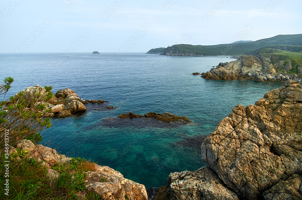 High cliffs in the ocean. Rocky islands and rocks in Orlik Bay in the Sea of Japan. Far East.