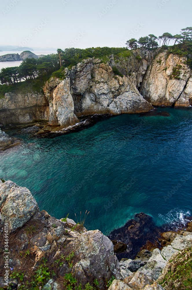 Fototapeta premium High cliffs in the ocean. Rocky islands and rocks in Orlik Bay in the Sea of Japan. Far East.