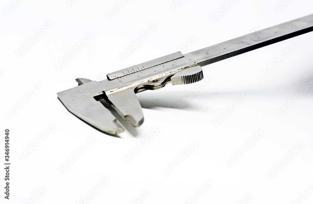 Detail view of a metallic caliper used to measure the distance between two opposite sides of an object