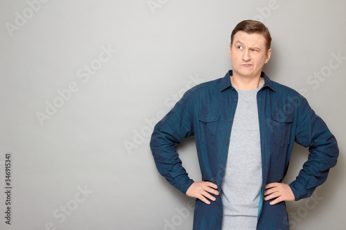 Portrait of serious puzzled mature man thinking hard and making choice