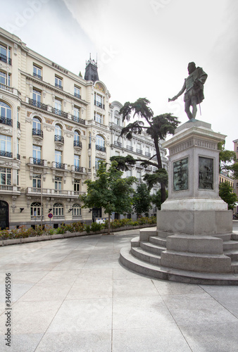 Plaza de las Cortes with statue of Miguel de Cervantes and to the building Plus Ultra Seguros, Madrid, Spain