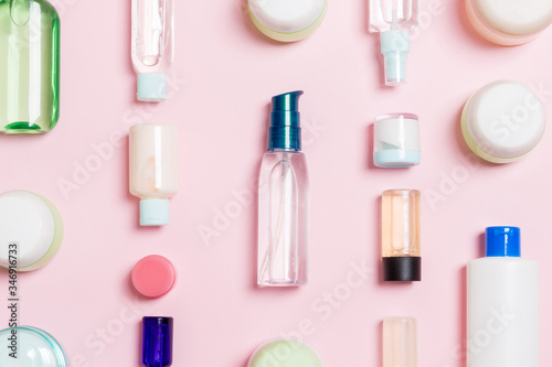 Group of plastic bodycare bottle Flat lay composition with cosmetic products on pink background empty space for you design. Set of White Cosmetic containers, top view with copy space