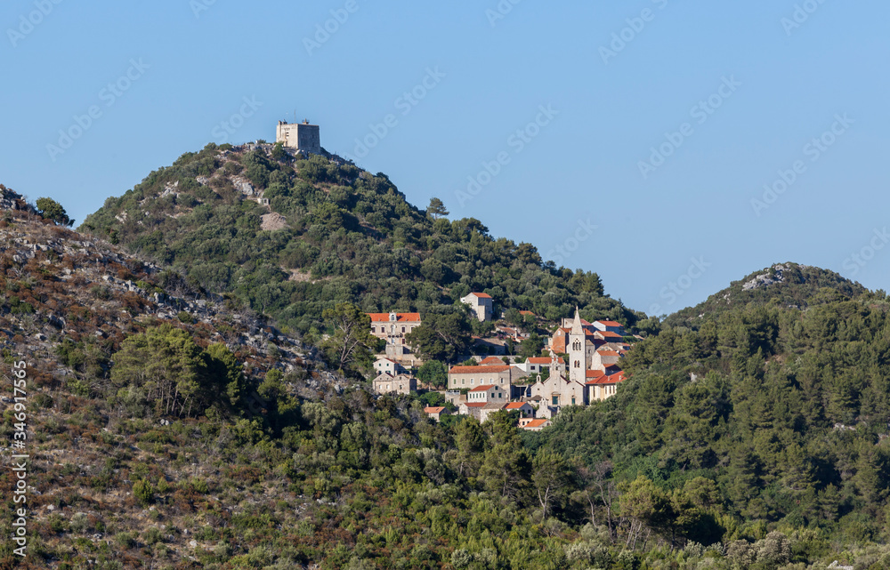 Naklejka premium Small town Lastovo with a fortress on the hill on island Lastovo in Dalmatia, Croatia