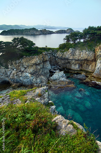 High cliffs in the ocean. Rocky islands and rocks in Orlik Bay in the Sea of Japan. Far East.
