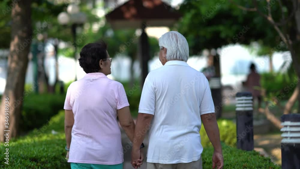 Happy old couples smiling in the park in the morning.Happy senior couple relaxing in autumn park.