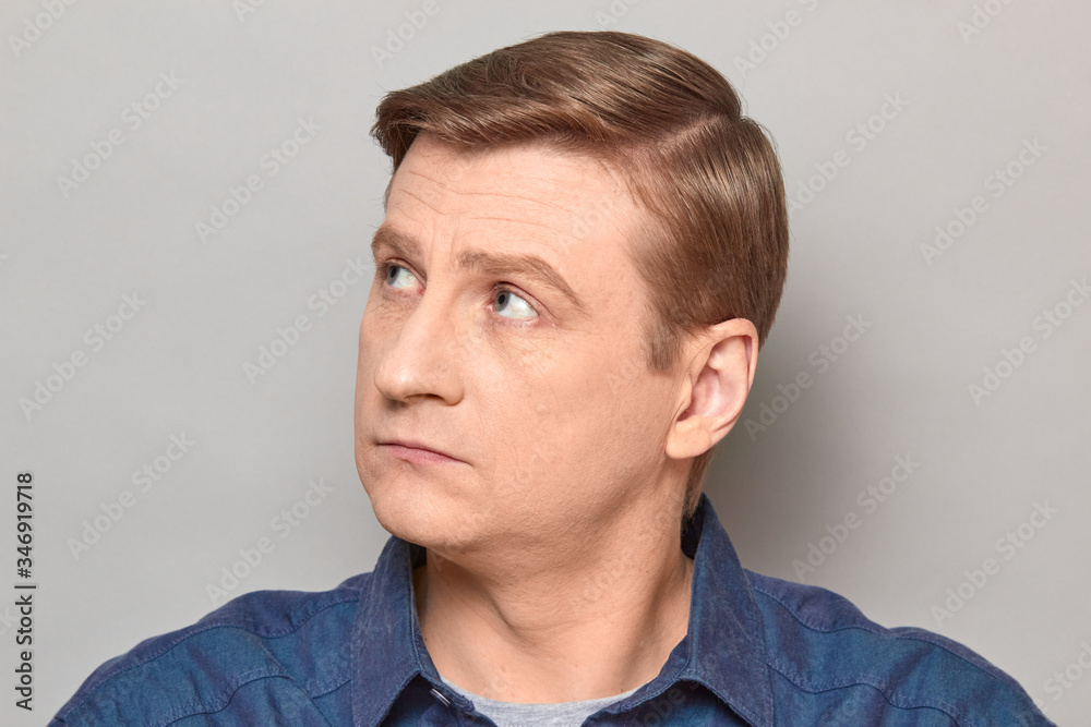 Naklejka premium Portrait of blond mature man with neutral expression on face