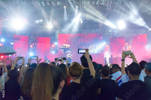 concert.crowd at concert music festival at night. silhouettes with hands of people at concert music festival. 