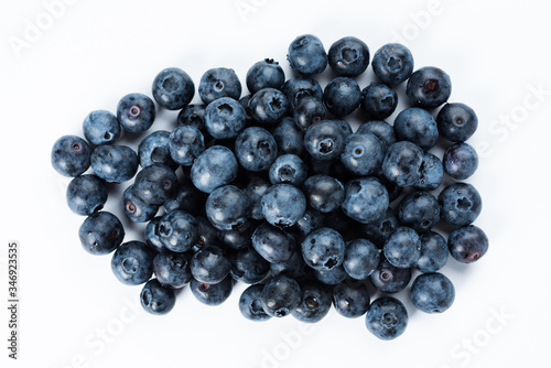Blue berries on a white background. Fresh delicacy, top view.